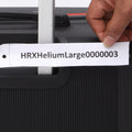Hard-shell luggage close-up with printed label on the front and raised handle tube