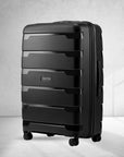 Black large check-in trolley suitcase, ribbed panels, four spinner wheels