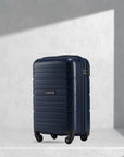 Navy blue cabin trolley with hard shell, telescopic handle, and 4 wheels