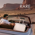 Polycarbonate suitcase on seat with telescopic handle extended