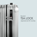 Recessed TSA lock on the side of a silver hard-shell suitcase