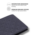 Dark bi-fold leather wallet corner close-up with repeating R monogram embossing.