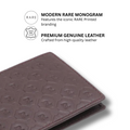 Burgundy leather bi-fold wallet with embossed monogram texture and stitched edges