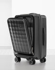 Dark grey polycarbonate cabin trolley with quilted front panel and side handle, spinner wheels
