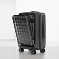 Dark grey polycarbonate cabin trolley with quilted front panel and side handle, spinner wheels
