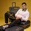 Large black check-in trolley with upright handle, glossy shell, and 8 caster wheels