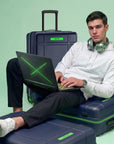 Large check-in trolley with navy polycarbonate body and green-trim accents