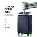 Navy polycarbonate check-in trolley front view with top handle and green wheel accents