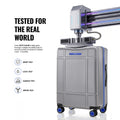 Silver polycarbonate trolley suitcase with blue details and side-mounted handle on wheels