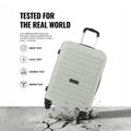 Light grey medium trolley suitcase with 4 wheels and side carry handle, durable hard shell