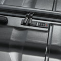 Large check-in suitcase front panel with zipper track and combination lock dials, black