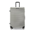 Hard-shell 8-wheel suitcase, silver with ribbed front and retractable handle