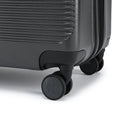 Medium check-in suitcase wheel and corner, dark hard shell with smooth rolling caster