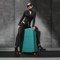 Teal hard-shell suitcase with telescopic handle and front spinner wheels.