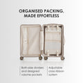 Open light beige hard-shell suitcase with packing organizer pockets and dividers