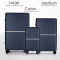 Stacked dark blue hard-shell trolley luggage in large, medium, and cabin sizes