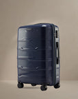 Hard-shell polypropylene check-in trolley suitcase, blue, with 8 wheels and side handle