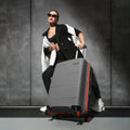 Grey hardshell check-in suitcase with ridged texture and four spinner wheels, 65 cm