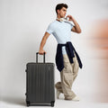 Charcoal grey medium check-in suitcase with telescopic handle and four wheels