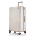 Beige hard-shell polycarbonate trolley suitcase angled view with front handle and four wheels