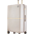 Beige hard-shell polycarbonate trolley suitcase with gold trim, side handle and four wheels