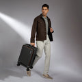 Black hard-shell trolley suitcase with laptop compartment and four spinner wheels