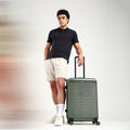 Dark green hard-shell 8-wheel suitcase with telescopic handle, medium size