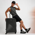 Charcoal grey ridged check-in suitcase, top handle, 8 spinner wheels
