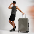 Small cabin suitcase in light grey with telescopic handle and spinner wheels