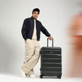 Large check-in suitcase with telescopic handle and wheels, charcoal color