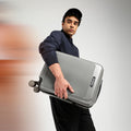 Silver hard-shell check-in suitcase with telescopic handle and 8 spinner wheels