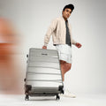 Large check-in suitcase with telescopic handle and wheels, silver-gray finish