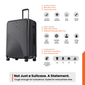 Charcoal hard-shell suitcase with top handle, corner details, and multiple spinner wheels.