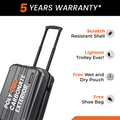 Black check-in suitcase close-up, ribbed hard shell, top handle and spinner wheels