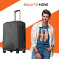 Charcoal grey medium suitcase with grooved shell, corner protectors, telescopic handle