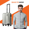 Small cabin suitcase, silver hard-shell with vertical ridges and four spinner wheels