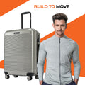 Medium check-in suitcase with 8 wheels, silver hard shell and black top handle