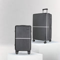 Hard-shell luggage pair with upright cases, telescopic handles, and spinner wheels