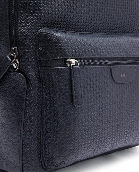 Black textured leather backpack side zipper pocket with pull tab and inner compartment