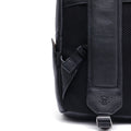 Black leather backpack side view with adjustable strap and metal buckle hardware