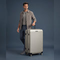 Large check-in polycarbonate suitcase, silver ridged shell, spinner wheels