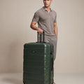 Large check-in suitcase, dark green hard shell with 8 wheels and telescopic handle