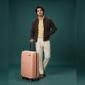 Small cabin suitcase, peach polypropylene with 8 spinner wheels and side handle