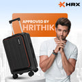 Black hardshell trolley suitcase with red trim and side handle, angled view