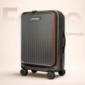 Dark gray hard-shell trolley suitcase with orange edge trim and spinner wheels