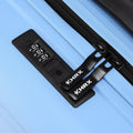 Light blue suitcase with black combination lock and cross straps on shell