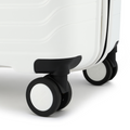 Close-up of white suitcase corner with black mounting and black spinner wheels.