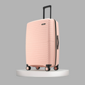 Peach large check-in suitcase side view with upright handle and 8 wheels