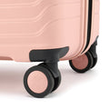 Large check-in suitcase, peach, close-up of wheels and corner trim