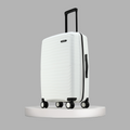 White medium hard-shell suitcase standing on four visible spinner wheels